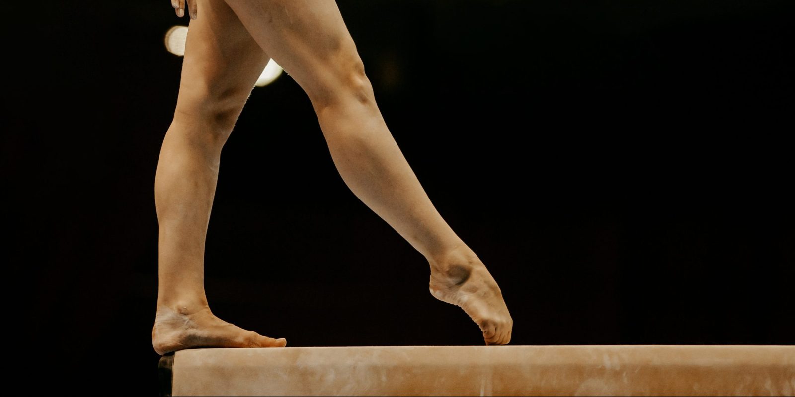 side view legs female gymnast in balance beam gymnastics
