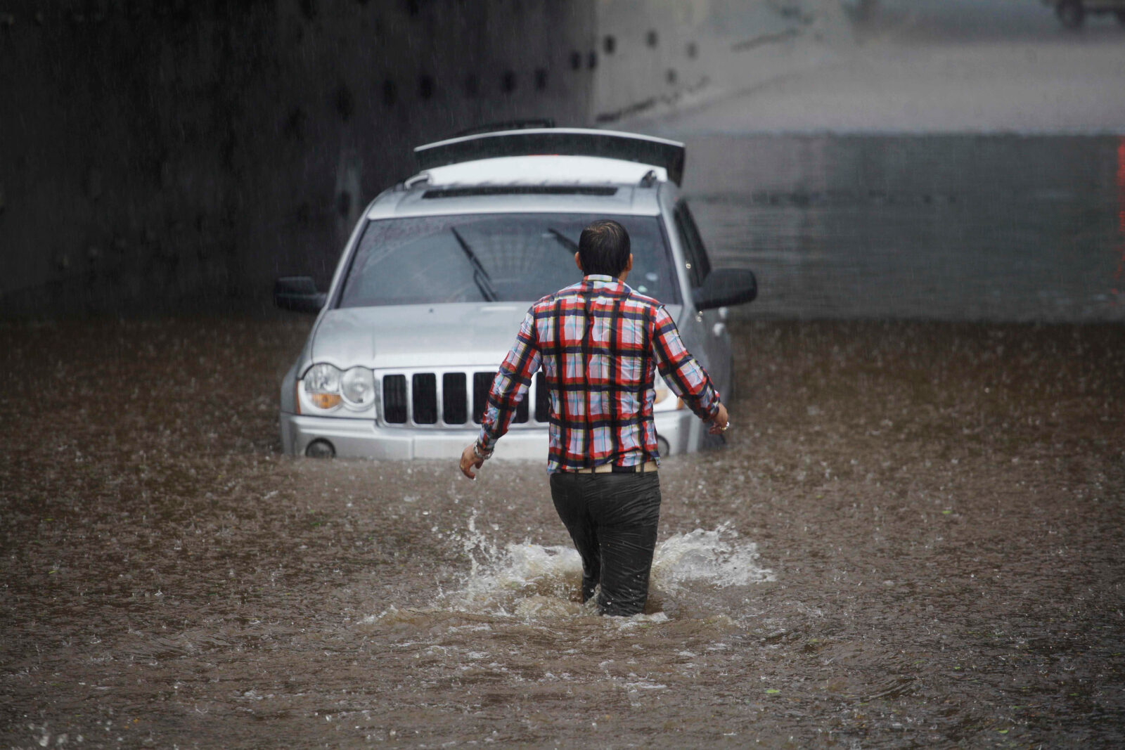 Driver gets stuck with his car in Marginal avenue during a big flood amid heavy rains in Sao Paulo, Brazil.