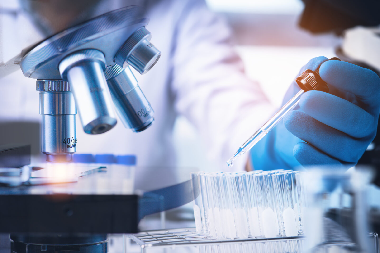 Scientist with equipment and science experiments ,laboratory glassware containing chemical liquid for design or decorate your content,microscopoe .Pipette dropping a sample into a test tube