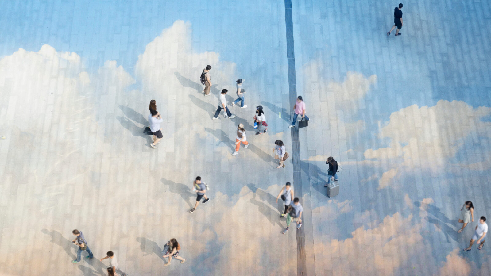 top aerial view people walk on the pedestrian city street walkway on pavement concrete reflect cloud and blue sky.